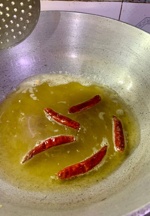 Step 2.9: Repeat the same process for the peanuts, roasted channa, dried coconut, dry red chillies and curry leaves