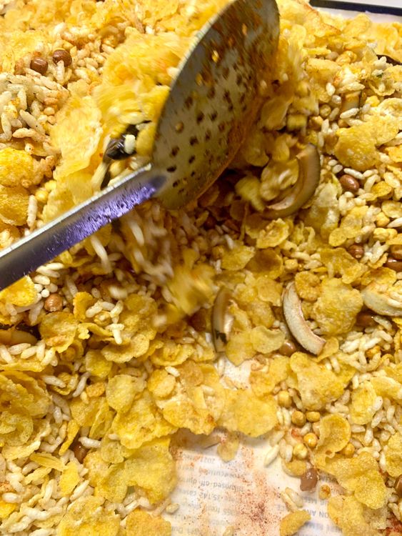 Step 2.1: Gently toss the spices and fried ingredients with a slotted spoon until evenly mixed