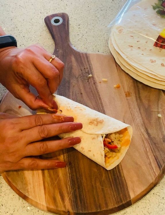 Step 1.2: Add grated cheese on top and wrap the tortilla from three sides