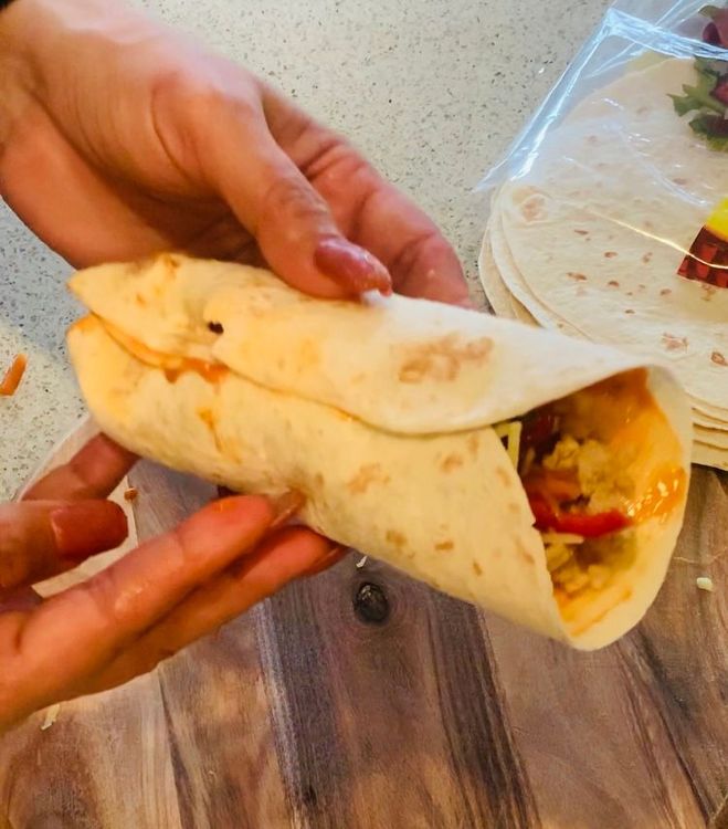 Step 1.3: Add grated cheese on top and wrap the tortilla from three sides