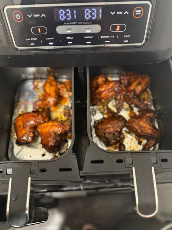 Step 2.1: After 25 minutes, remove the chicken wings, coat them in the wet seasoning, and return them to the air fryer for 6 minutes