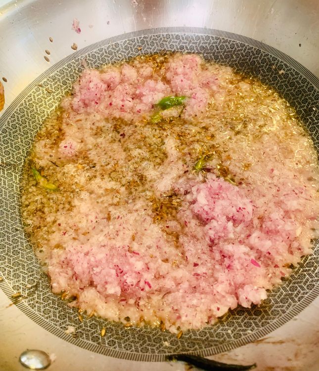 Step 1.1: Add the ground onion paste, mix and cook for 3-4 minutes or until pinkish