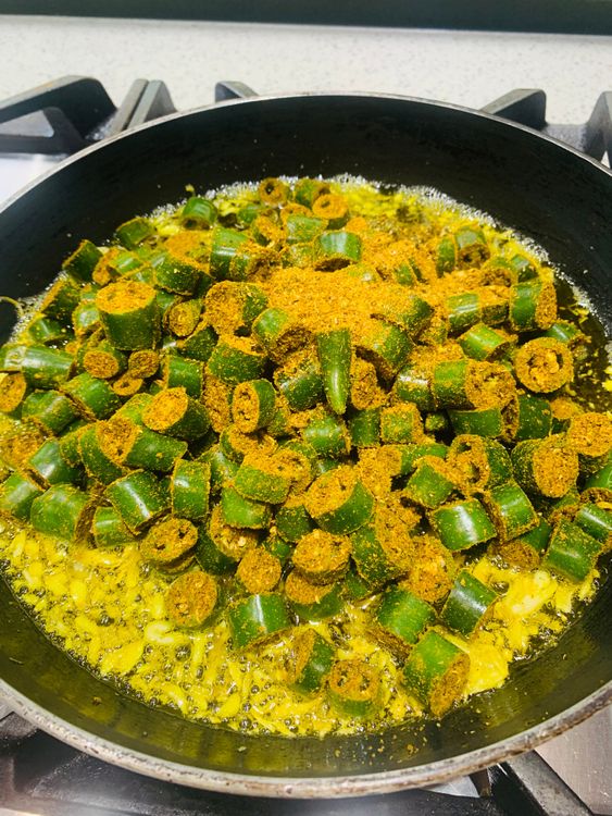 Step 1.1: Add the spiced green chillies to the pan and mix well to combine with the oil and garlic