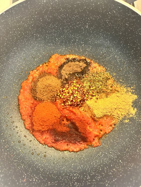 Step 1.1: Stir in the paprika, cumin, red chili powder, chili flakes, black pepper, and salt