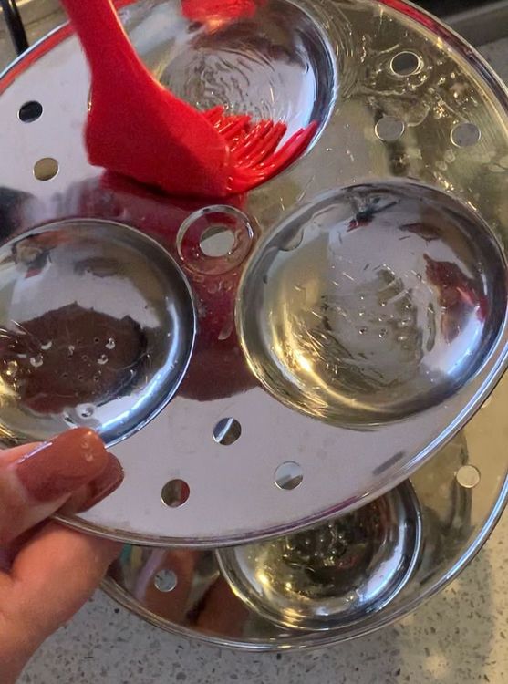 Step 1.1: Grease the idli plates of the stand with oil and set aside