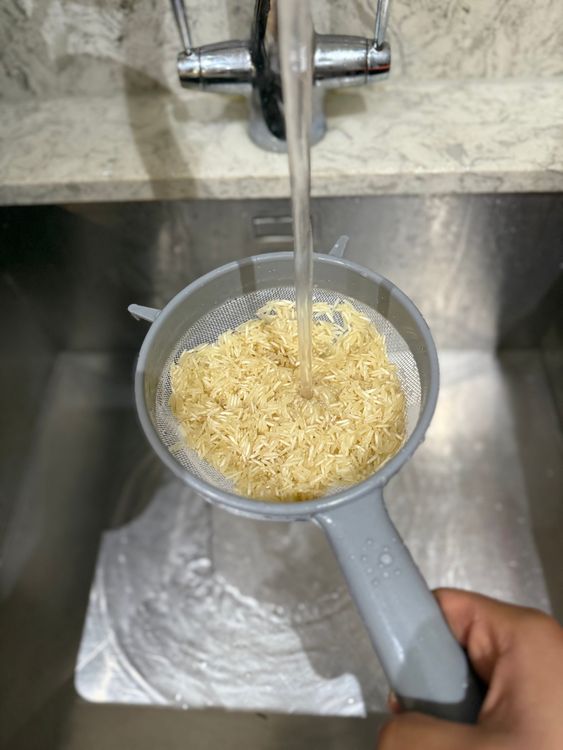 Step 3.1: Rinse the rice in a sieve until the water runs clear, then set aside