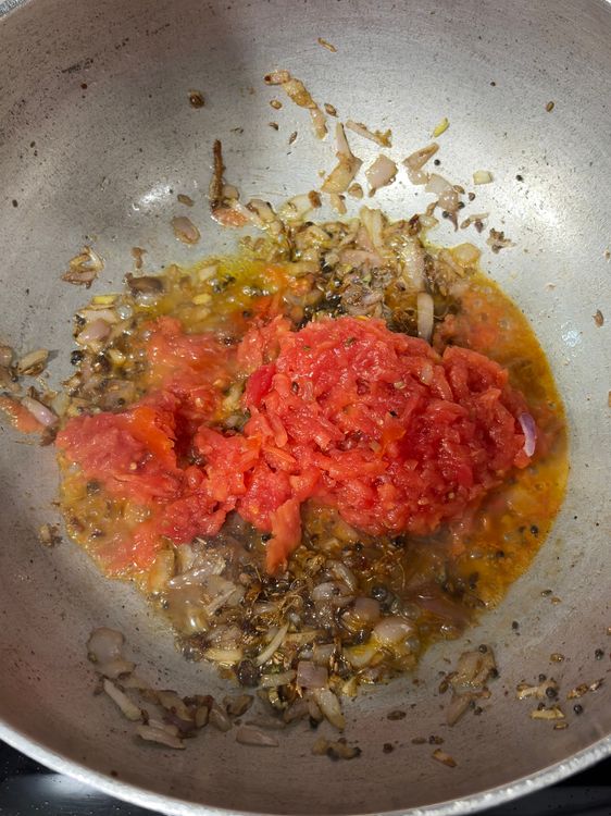 Step 2.1: Add grated tomatoes and cook until soft and oil begins to separate