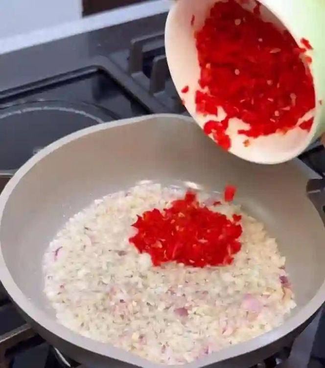 Step 1.1: Add coarsely ground red fresh pepper and stir fry for another minute