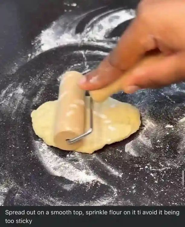 Step 2.1: Spread the dough on a smooth surface and sprinkle flour to prevent sticking