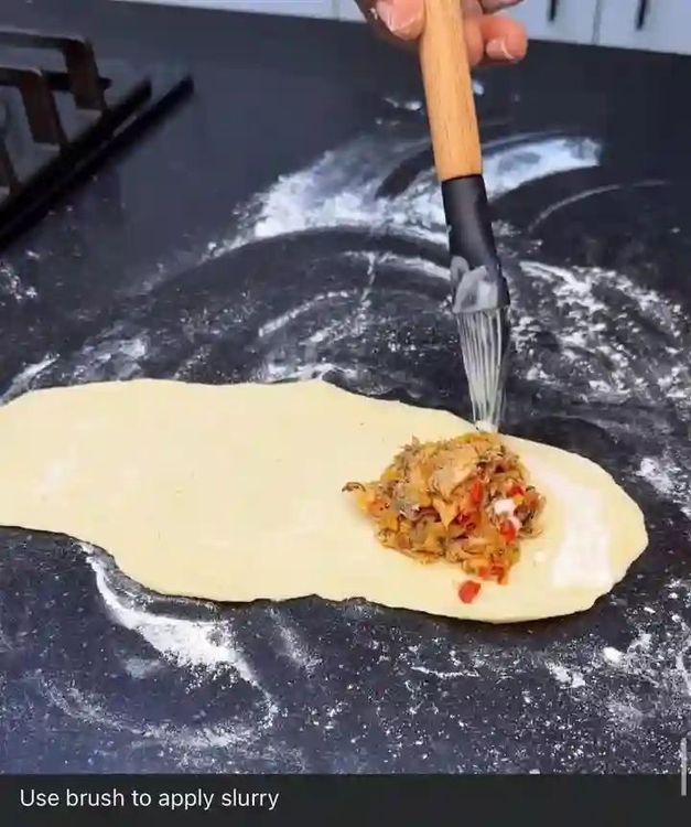 Step 3.2: Use a brush to apply slurry all around the edges of the dough