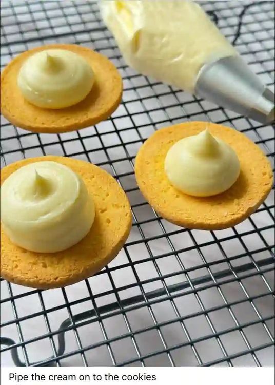 Step 3.1: Prepare the cream filling by piping cream onto the cookies