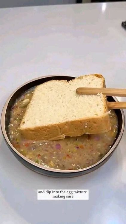 Step 1.2: Take a slice of bread and dip it into the egg mixture, ensuring all sides are fully covered
