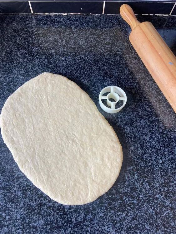 Step 2.2: Roll out the dough and use a doughnut cutter or a glass and bottle cap to shape the doughnuts
