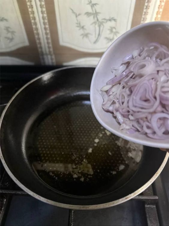 Step 1.3: Add oil to a pan and stir fry sliced onions for a few seconds