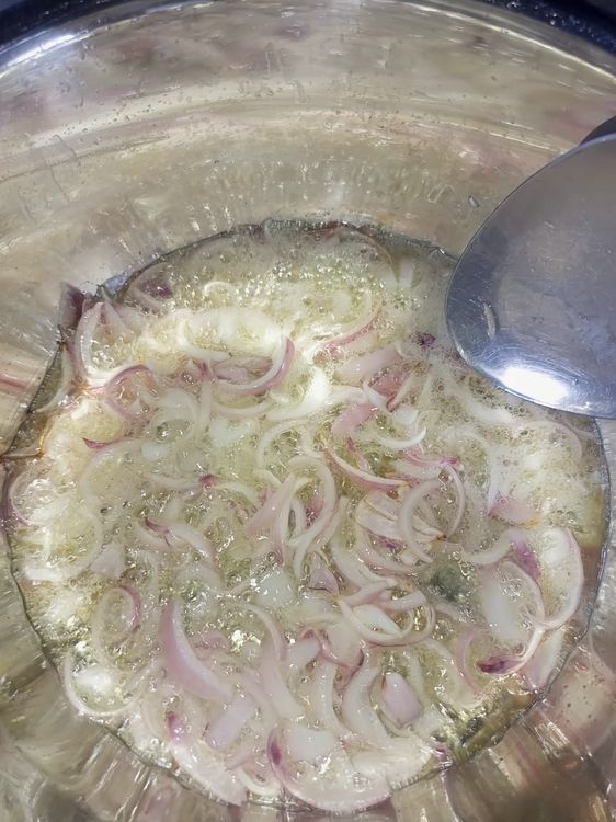 Step 1.3: Heat vegetable oil in a pot and stir-fry the sliced onions for 1 minute