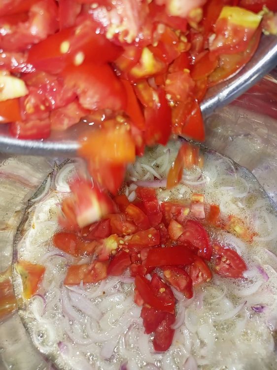 Step 1.3: Stir fry the onions for 1 minute, then add sliced fresh tomatoes