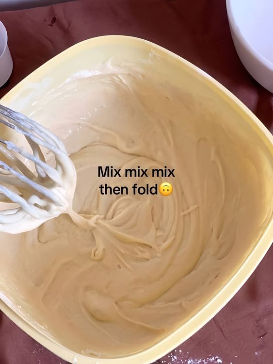 Step 1.2: Gradually add the flour and baking powder in two batches, folding gently to combine