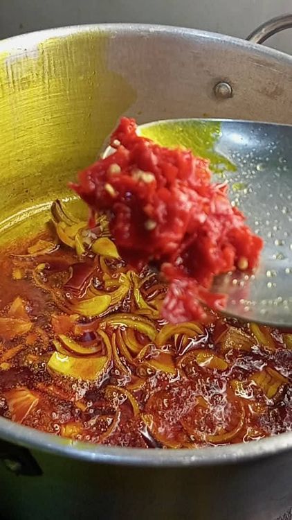 Step 1.1: Add onions and stir for a few seconds, then add half of the coarsely blended or pounded pepper