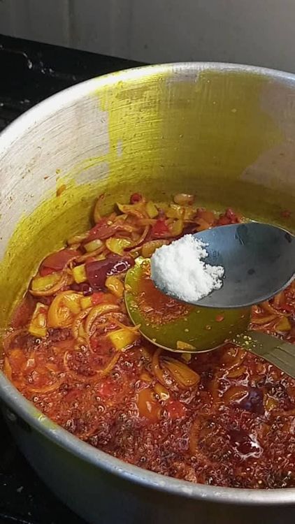 Step 1.1: Stir fry for 30 seconds, then add 2 seasoning cubes and half a teaspoon of salt