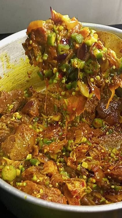 Step 1.1: After 2 minutes, open the pot and pour in a quarter portion of your chopped okra and half of the medium-sized chopped onion