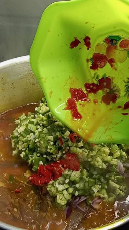 Step 1.1: After 1 minute, add the remaining portion of chopped okra and onion, along with the remaining coarsely blended fresh pepper, and stir together