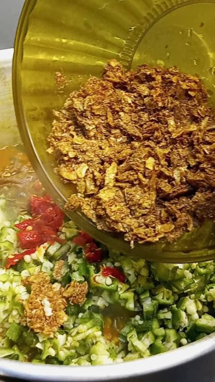 Step 1.3: After 1 minute, add the remaining portion of chopped okra and onion, along with the remaining coarsely blended fresh pepper, and stir together