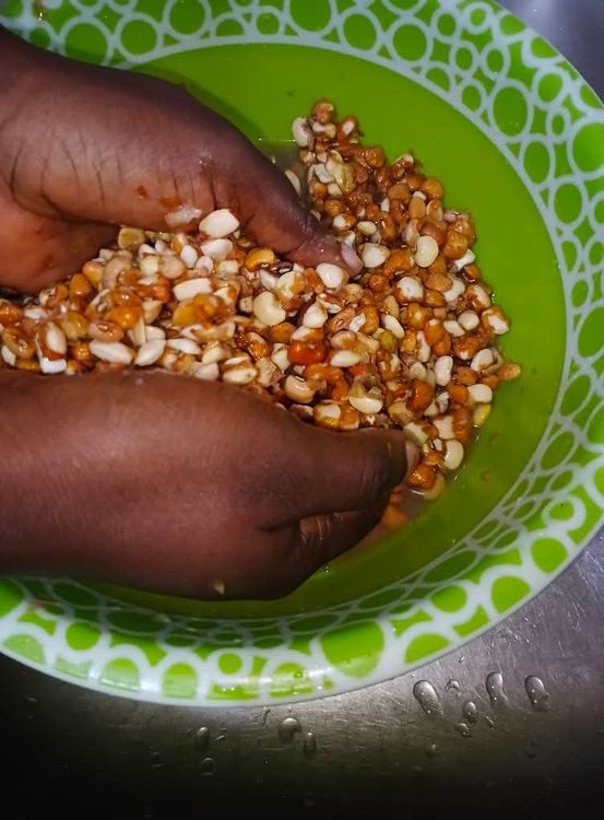Step 1.6: For a traditional procedure, pour one cup of water into your bowl of beans , , soak for 2 minute and rub them together with your hands until the chaff is separated
