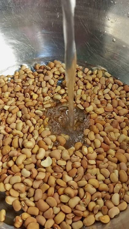 Step 1.4: For a traditional procedure, pour one cup of water into your bowl of beans , , soak for 2 minute and rub them together with your hands until the chaff is separated