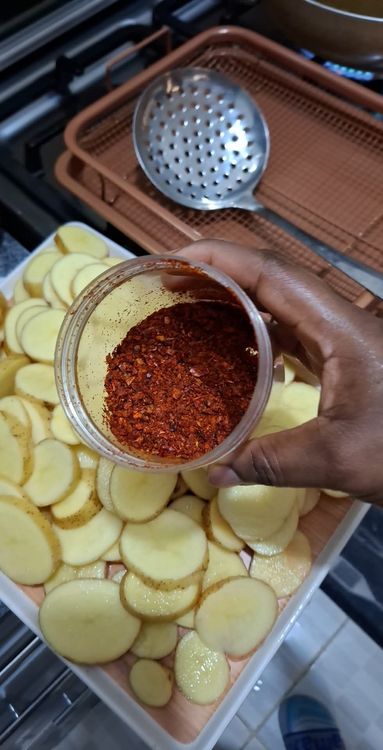 Step 1.2: Sprinkle Himalayan salt and chili flakes evenly over the sliced potatoes