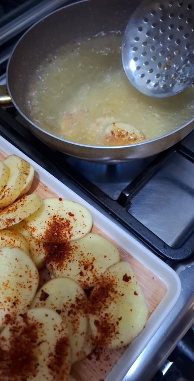 Step 1.4: Heat oil in a pan and fry the potato slices until both sides are golden brown and crispy