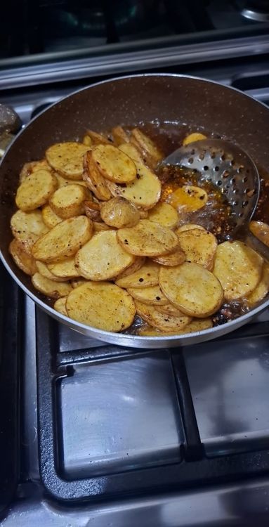 Step 1.3: Heat oil in a pan and fry the potato slices until both sides are golden brown and crispy