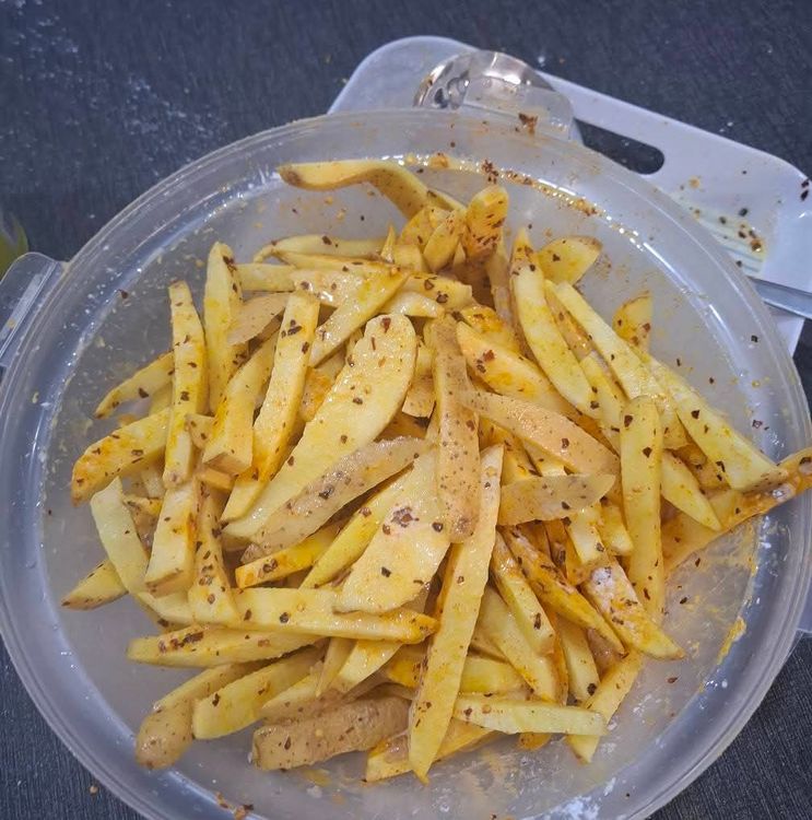 Step 1.4: Sprinkle Himalayan salt, dry crushed red pepper, ground turmeric, and corn flour over the potatoes