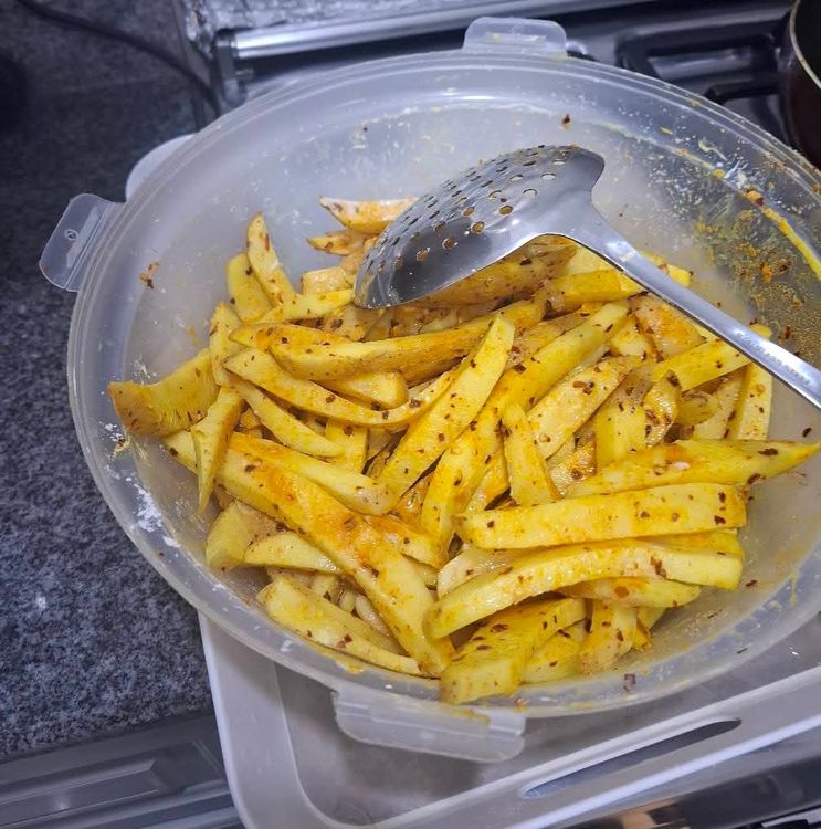 Step 1.2: Sprinkle Himalayan salt, dry crushed red pepper, ground turmeric, and corn flour over the potatoes