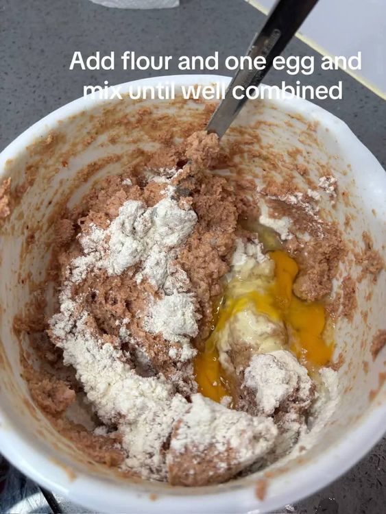 Step 1.1: Pour the blended mixture into a deep bowl, add flour and one egg, and mix until well combined