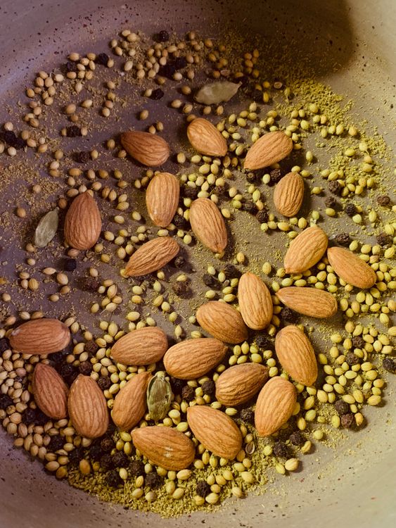 Step 2.1: Add coriander, fennel, green cardamoms, black peppercorns, almonds, and dry roast until fragrant