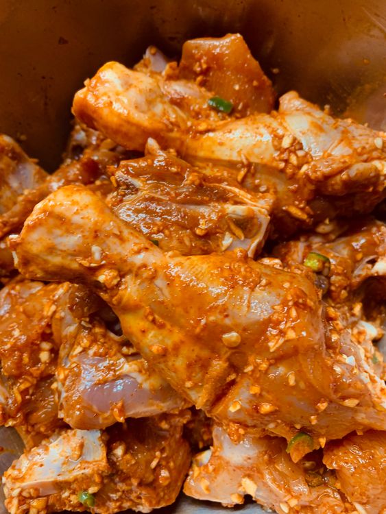 Step 1.2: Marinate chicken with minced garlic, salt, red chilli powder, kashmiri chilli powder, chopped green chilli, lemon or vinegar and turmeric