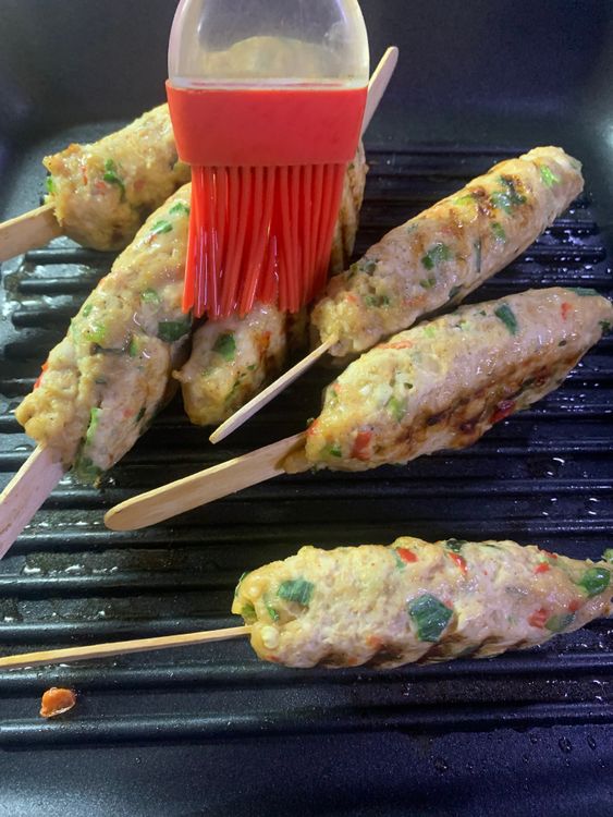 Step 1.1: Using a brush, apply a small amount of oil on the kebabs frequently to ensure that the chicken kebabs do not dry out