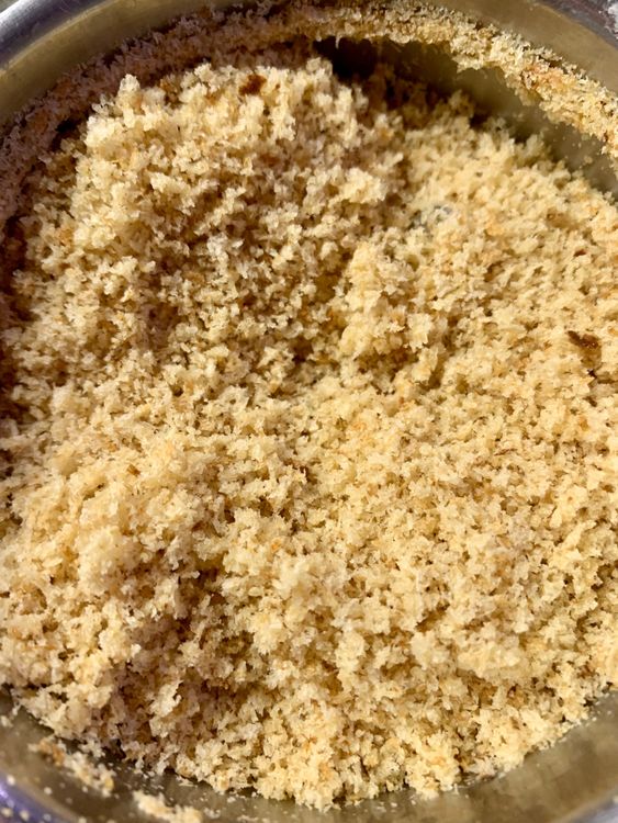 Step 1.1: Place the bread pieces in a food processor and pulse until the bread is ground into fine crumbs