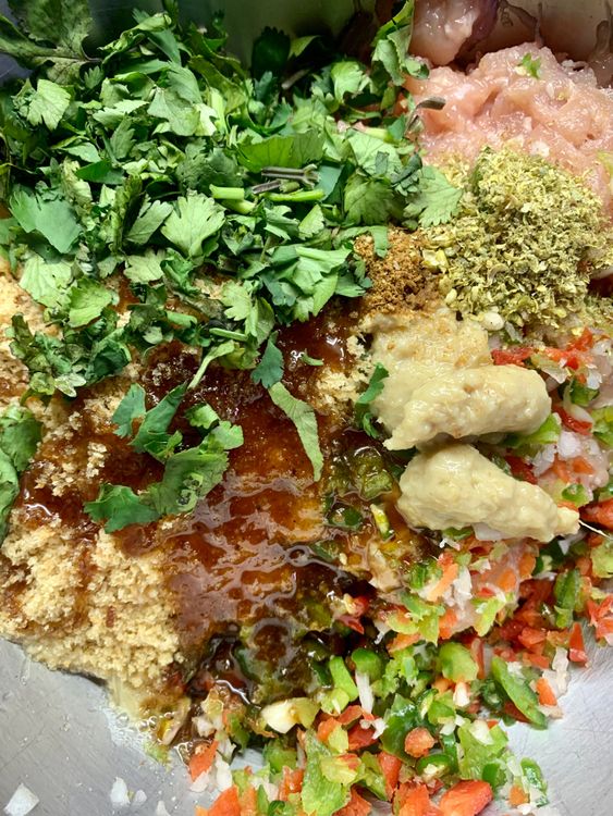 Step 1.1: Now add bread crumbs, green chilies, ginger garlic paste, red chilli powder, cumin powder, coriander powder, tamarind chutney, lemon juice, semolina, and salt
