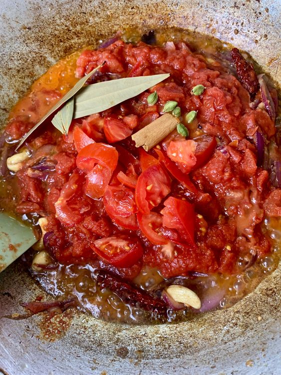 Step 3.1: Add tomatoes, bay leaves, cinnamon, and cardamom