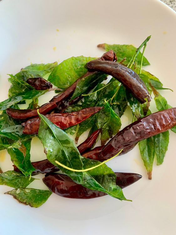 Step 2.1: Fry dry red chillies and curry leaves in the same oil, then remove and set aside