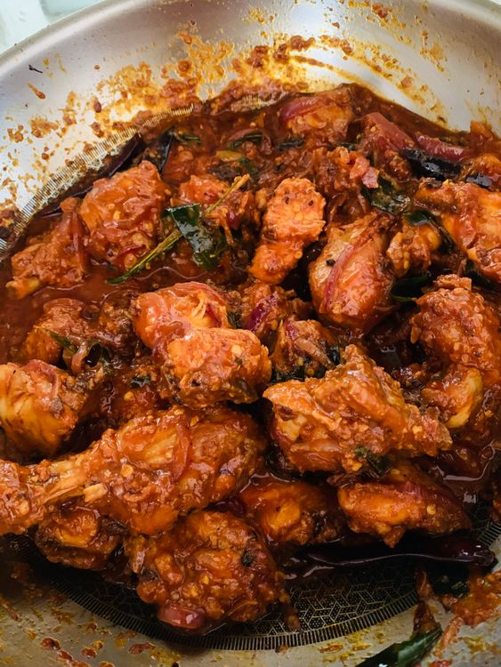 Step 3.1: Add fried chicken, lemon juice, and fried red chilli-curry leaves back into the pan