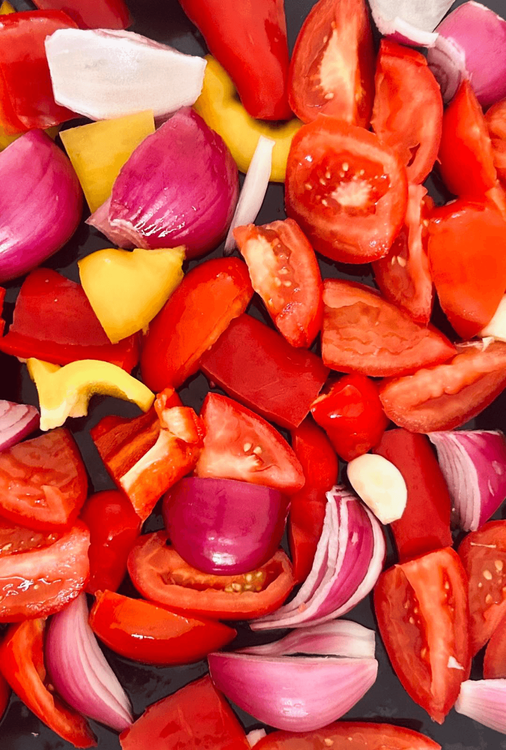 Step 1.1: Place the chopped vegetables, whole garlic cloves, and ginger on a baking tray in a single layer