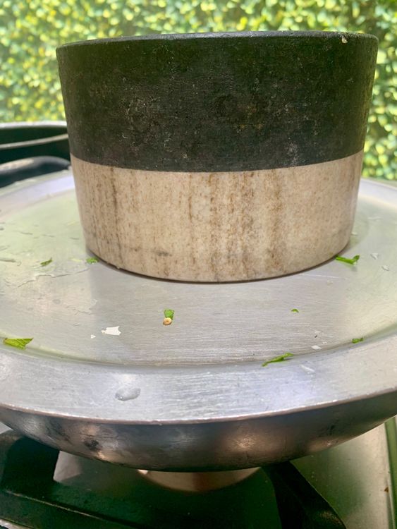 Step 4.1: Cover the pot, put some weight on it, and cook on a low flame for 10–12 minutes