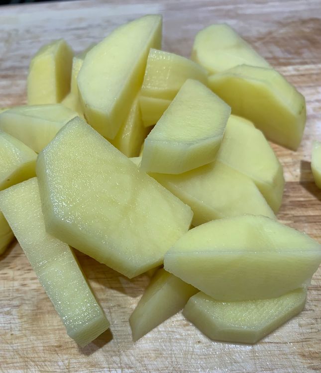 Step 1.1: Peel and cut the potatoes into cubes or wedges