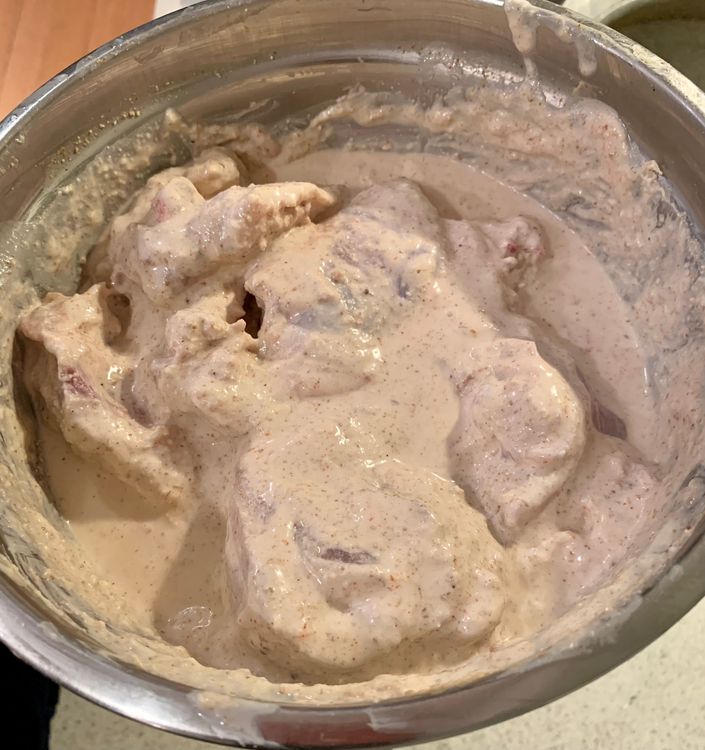 Step 2.4: Put the chicken pieces in a mixing bowl and add the ground mixture, curd, red chilli powder, salt, ginger and garlic