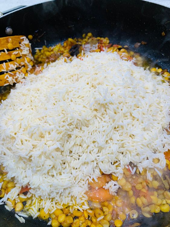 Step 4.1: Gently mix in the soaked rice, being careful not to break the grains