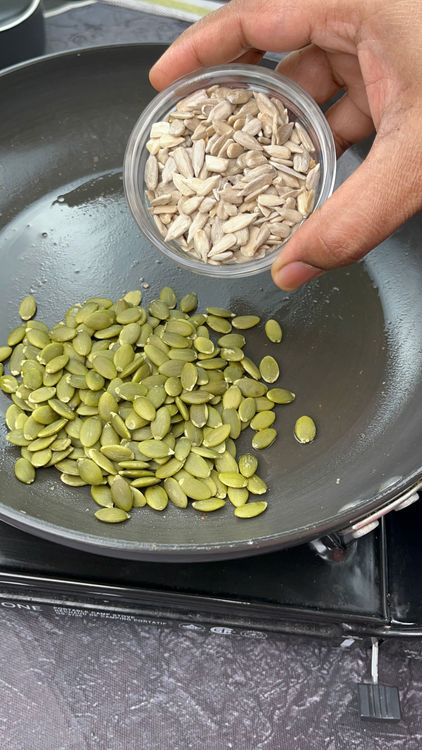 Step 2.1: In the same pan, dry roast sesame seeds, pumpkin seeds, and peanuts until the sesame seeds start crackling