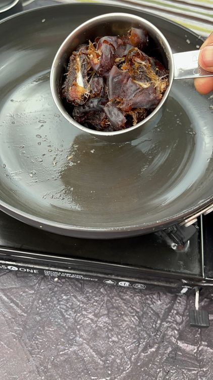 Step 5.1: Add 1 tsp ghee and roast seedless dates for 5–6 minutes on low flame until soft, then set aside