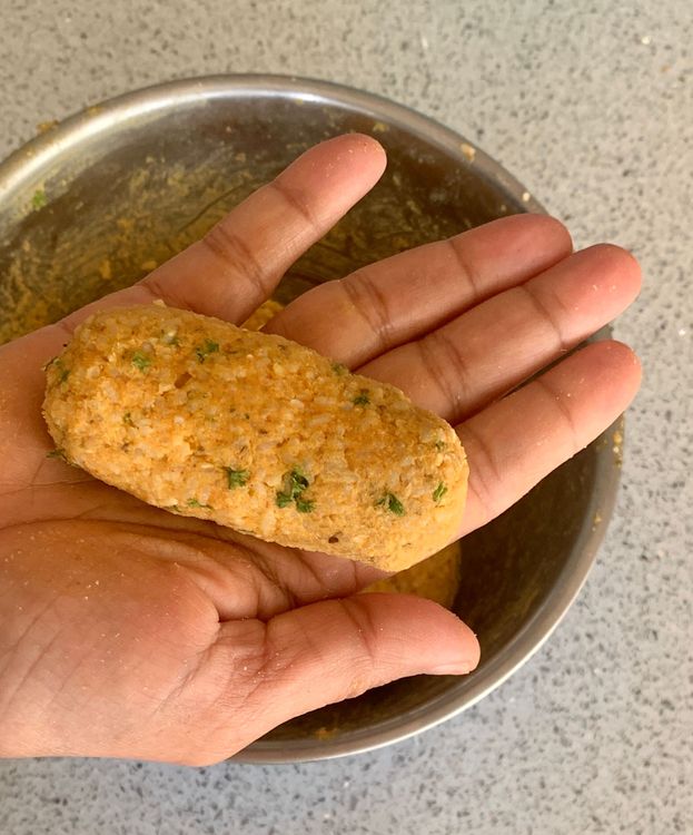 Step 1.1: Grease your palms with oil and take small portions of the dough